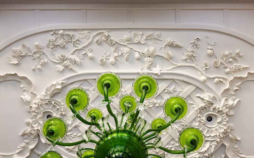 Hand-sculpted botanical bas-relief plaster ceiling with vines and florals in a Dallas dining room — Sherry Hayslip Interiors, photography by Julie Soefer