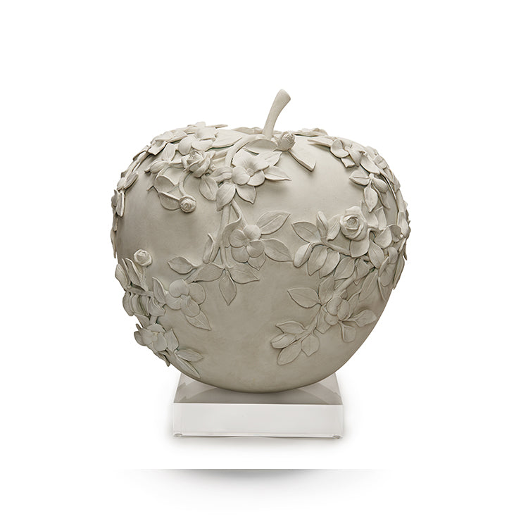 SegretoStone sculptural apple with hand-molded floral and leaf relief, photographed at Segreto Finishes studio