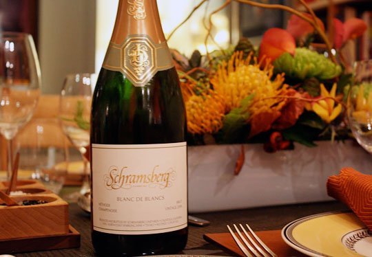 Thanksgiving table with warm seasonal tones, layered dishware, and floral centerpiece — Leslie Sinclair