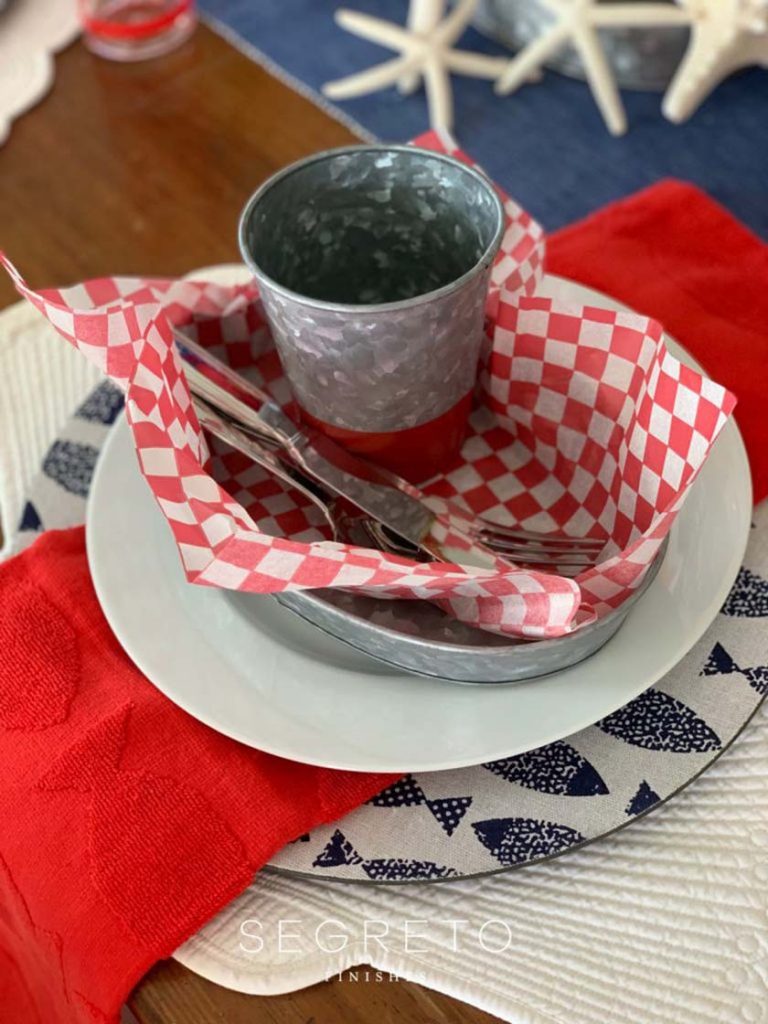 cup & silverware in paper napkin within a bowl
