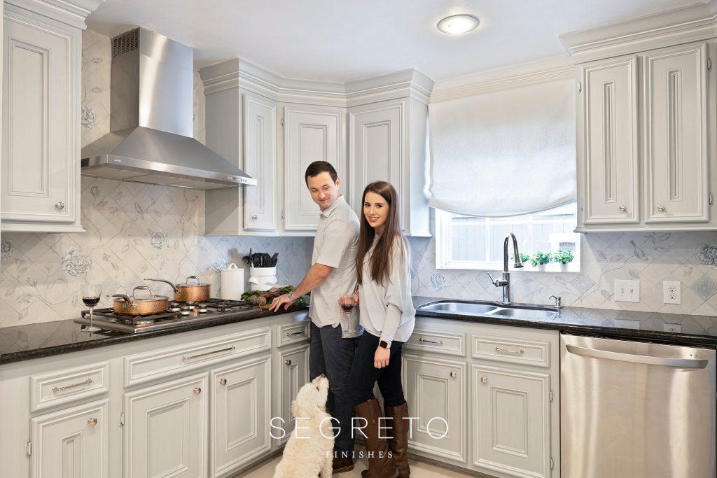 Newlywed couple in kitchen with dog